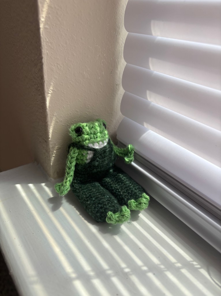 crochet long legged frog in overalls amigurumi sitting