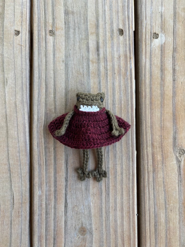 dark green crochet frog in babydoll dress